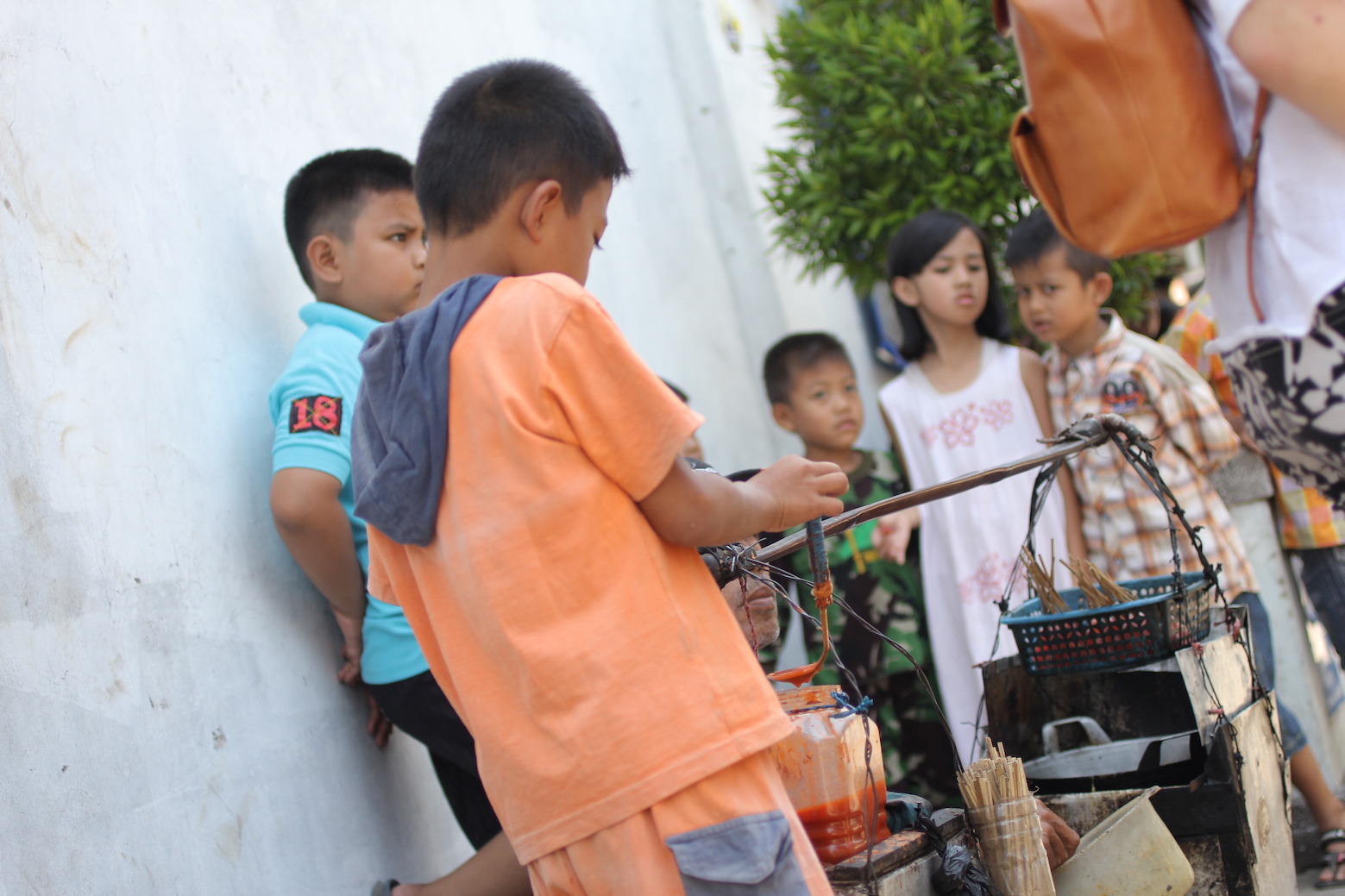 Children play with a hawker's stall in Babakan Ciparay sub-district, Bandung - Mokstimofeevic Children play with a hawker's stall in Babakan Ciparay sub-district, Bandung - Mokstimofeevic