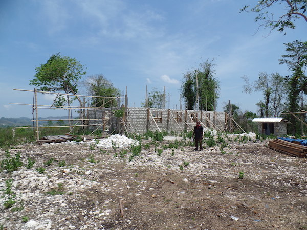 The Village Head shows the new Village Office in Matawai Kajawi that is being built at the top of a hill formerly just used for herding buffalo - Jacqueline Vel, Sumba, November 2014. The Village Head shows the new Village Office in Matawai Kajawi that is being built at the top of a hill formerly just used for herding buffalo - Jacqueline Vel, Sumba, November 2014.
